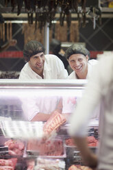 Male butchers working on counter - CUF40161