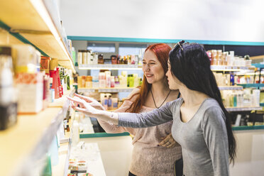 Zwei Frauen in einem Kosmetikgeschäft diskutieren über Produkte - WPEF00669