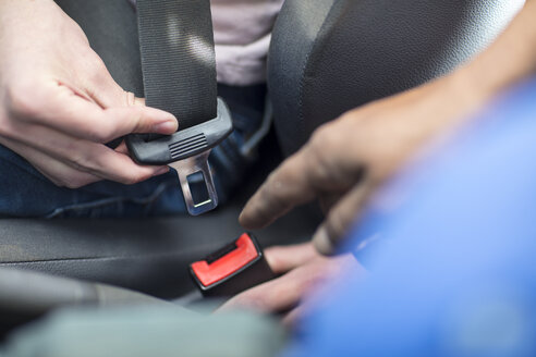 Männliche Hände im Auto, die den Sicherheitsgurt anlegen - ZEF15780