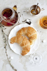 Croissants, honey and tea on table - CUF40192