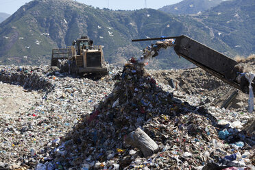 Machinery dumping waste in landfill - CUF40277