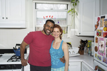 Mature couple in kitchen, portrait - CUF40353