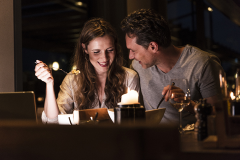 Smiling couple having dinner together stock photo