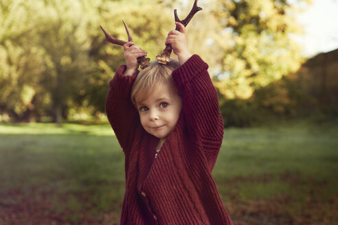 Toddler using sticks as antlers - CUF40429