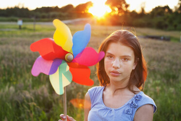 Girl holding toy windmill - CUF40438