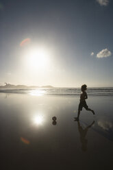 Man playing with football on beach, Lanzarote, Canary Islands, Spain - CUF40470