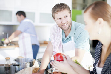 Friends cooking together in kitchen - CUF40593