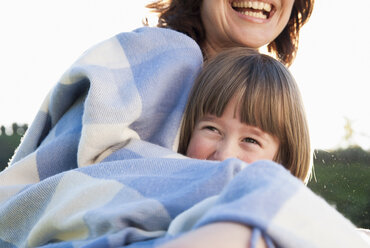 Mother and daughter wrapped in blanket - CUF40708