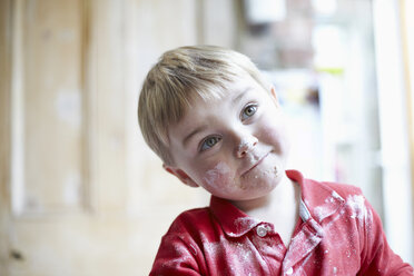 Boys face covered in flour in kitchen - CUF40725