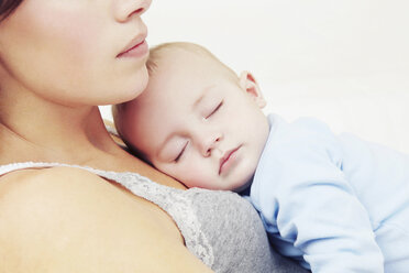 Mother holding sleeping baby girl - CUF40882