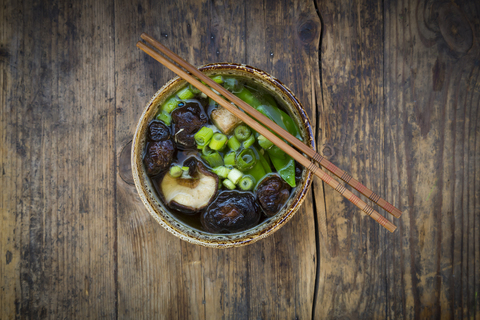 Bowl of Japanese miso soup with sugar peas, shitake mushrooms, tofu and mung sprouts stock photo