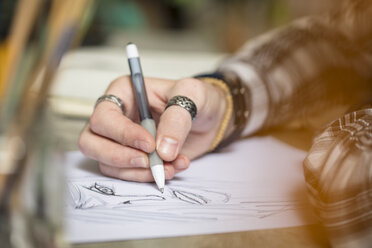 Close-up of artist drawing a sketch - ZEF15857