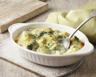 Broccoli baked in cheese sauce on wooden board - CUF41153