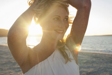 Close up of blond woman on beach at dusk, Cape Town, South Africa - CUF41324
