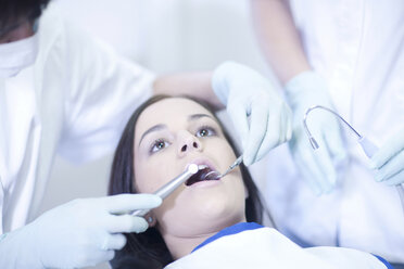 Dentist examining patients teeth - CUF41549