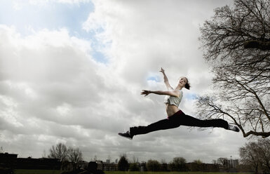 Woman doing ballet leap - CUF41823