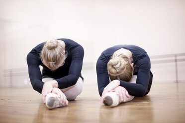 Two ballerinas in pose on studio floor - CUF41907