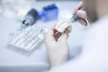 Dental technician working on denture - CUF41914