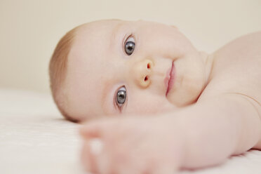 Close up of baby in crib playing - CUF42064