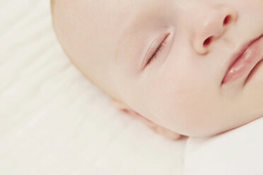 Close up of baby in crib sleeping - CUF42070