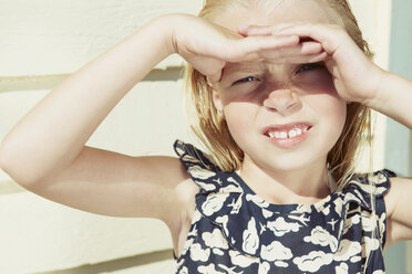 Child covering her eyes from sun glare - CUF42226