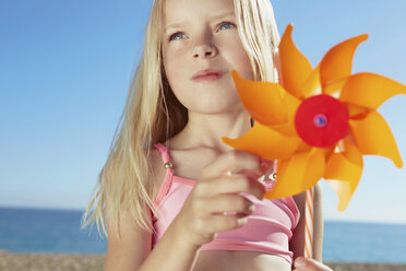 Girl holding toy windmill - CUF42227