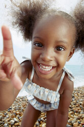 Child posing for camera at beach - CUF42234