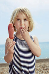 Child with fingers on lip holding ice lolly - CUF42235