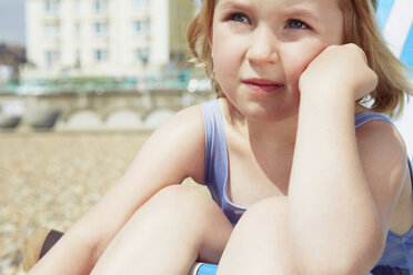 Child daydreaming on beach - CUF42239