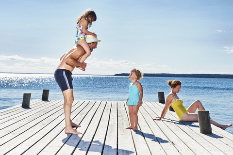 Eltern und zwei junge Mädchen am Pier, Utvalnas, Gavle, Schweden, lizenzfreies Stockfoto