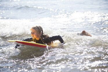 Portrait of girl on surfboard, Wales, UK - CUF42712
