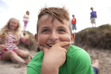 Portrait of boy with hand on chin smiling, Wales, UK - CUF42718