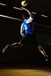 Volleyball player jumping for ball by net - CUF42720