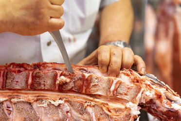Butcher cutting up pork - AFVF00781