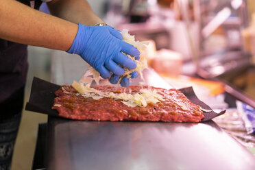 Woman filling minced meat with cheese - AFVF00782