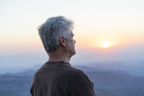 Spain, Catalonia, Man looking at sunset in the mountains - AFVF00792