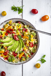 Bowl of bulgur salad with bell pepper, tomatoes, avocado, spring onion and parsley - SARF03831