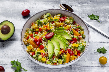 Bowl of bulgur salad with bell pepper, tomatoes, avocado, spring onion and parsley - SARF03836