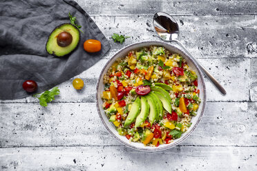 Bowl of bulgur salad with bell pepper, tomatoes, avocado, spring onion and parsley - SARF03837