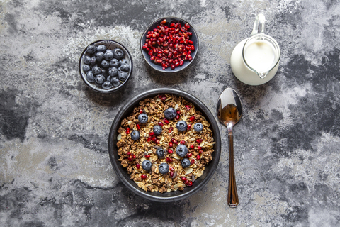 Bowl of muesli with blueberries and pomegranate seed stock photo