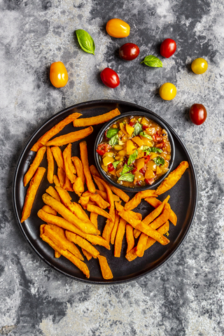 Homemade sweet potato fries and bowl of tomato basil dip stock photo