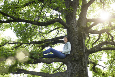 Smiling blond woman relaxing in nature - PNEF00767