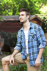 Portrait of young man wearing blue checked shirt - CUF43084