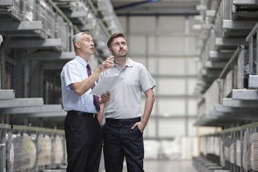 Worker and manager checking products in engineering warehouse - CUF43411