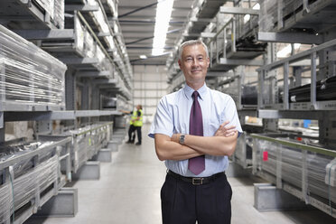 Portrait of manager in engineering warehouse - CUF43413