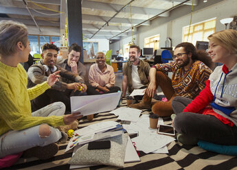 Creative business team meeting, brainstorming in circle on floor - CAIF21025