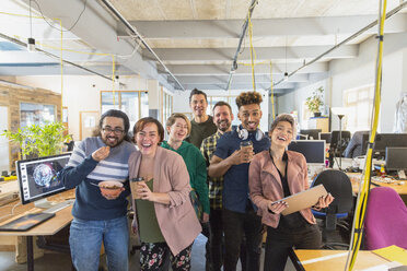 Portrait happy, playful creative business team in open plan office - CAIF21077