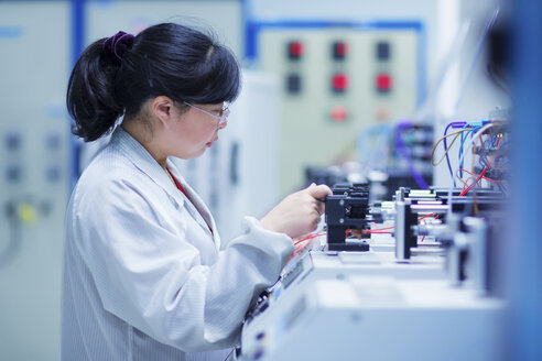 Worker at small parts manufacturing factory in China - CUF43441