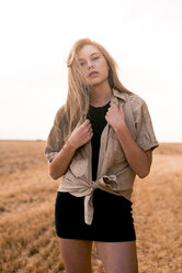 Beautiful young woman standing in field, portrait - ACPF00122