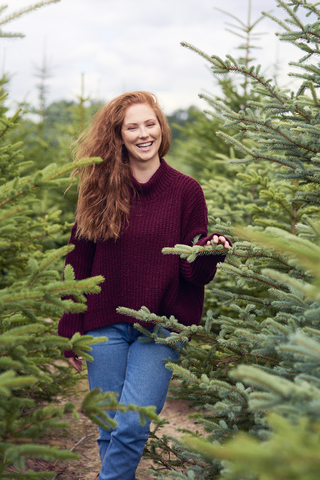 Portrait of laughing redheaded young woman in the woods stock photo